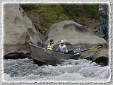A Helfrich Adventure Driftboat running rapids on the Rogue.